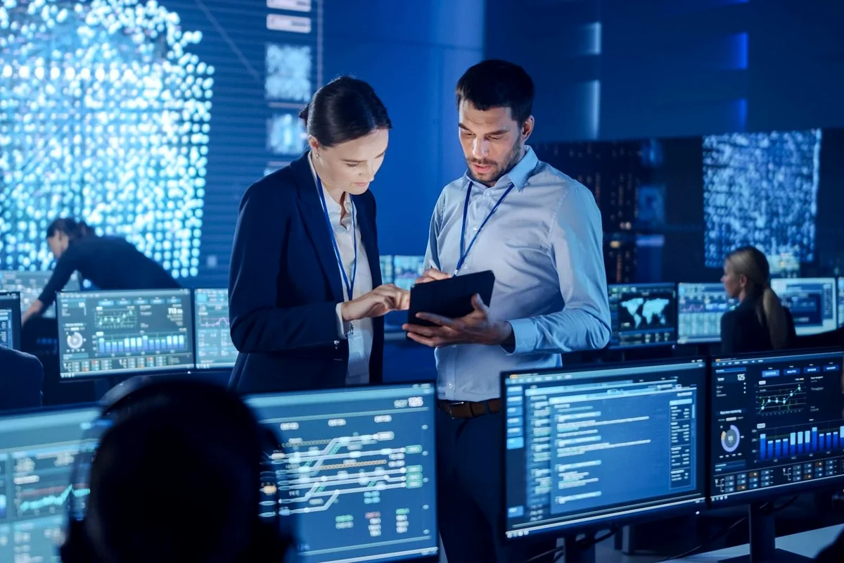 IT professionals monitoring managed systems in a network operations center